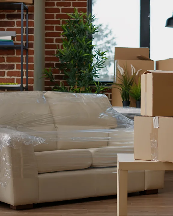 Wrapped sofa and boxes ready for furniture delivery